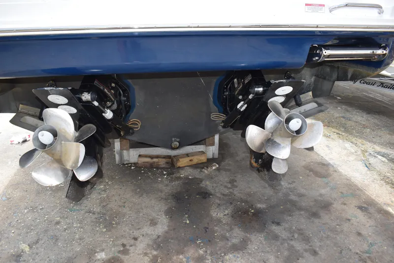 Slide: The Image of 2011 Sea Ray 310 Sundancer boat propellers on display in a maintenance area. - 5