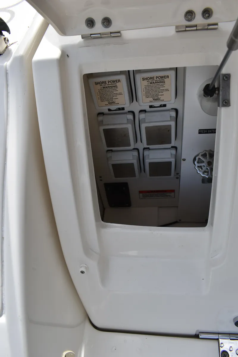 Slide: The Image of Electrical panel on a 2011 Sea Ray 310 Sundancer boat, featuring shore power connections. - 9
