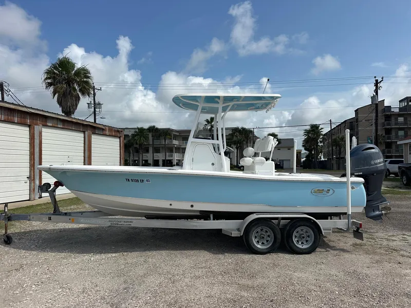 Slide: The Image of 2019 Sea Hunt BX 22 BR boat on trailer, parked outdoors under a cloudy sky. - 0