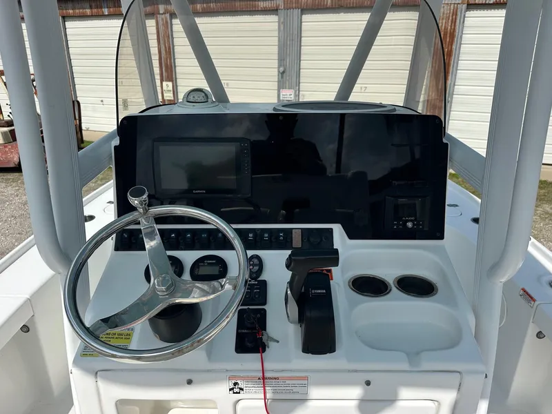 Slide: The Image of 2019 Sea Hunt BX 22 BR boat dashboard with steering wheel and control panel. - 2