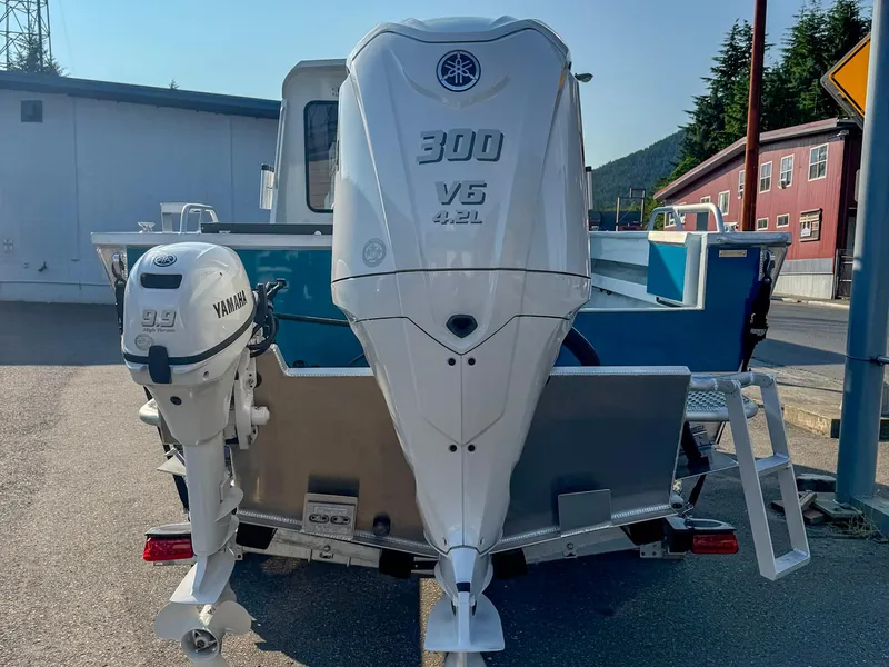Slide: The Image of 2024 Hewescraft 240 Ocean Pro ET HT with Yamaha outboard engines, parked outdoors. - 3