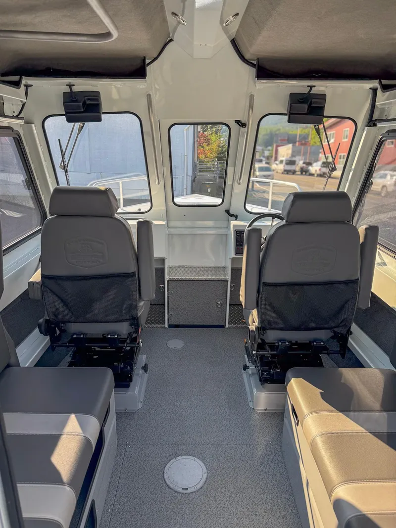 Slide: The Image of 2024 Hewescraft 240 Ocean Pro ET HT boat interior with seating and helm. - 4