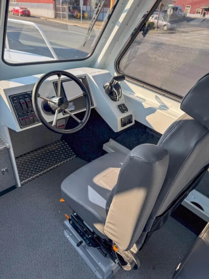 Slide: The Image of 2024 Hewescraft 240 Ocean Pro ET HT boat interior with steering wheel and captain's seat. - 5