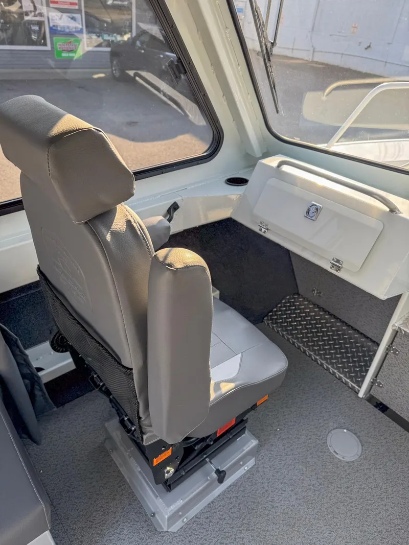 Slide: The Image of 2024 Hewescraft 240 Ocean Pro ET HT interior with gray captain's seat and dashboard. - 6