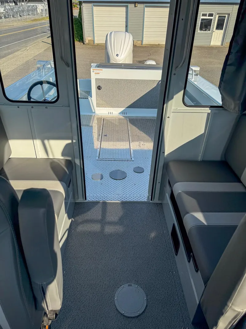 Slide: The Image of 2024 Hewescraft 240 Ocean Pro ET HT interior, featuring seating and deck view. - 9