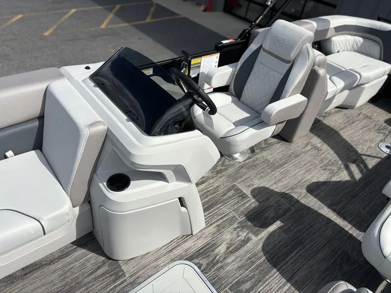 Slide: The Image of 2025 Godfrey SWEETWATER 2286 SB boat interior with modern seating and steering console. - 13