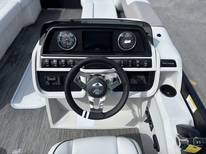 Slide: The Image of 2025 Godfrey SWEETWATER 2286 SB boat dashboard with modern steering and controls. - 16