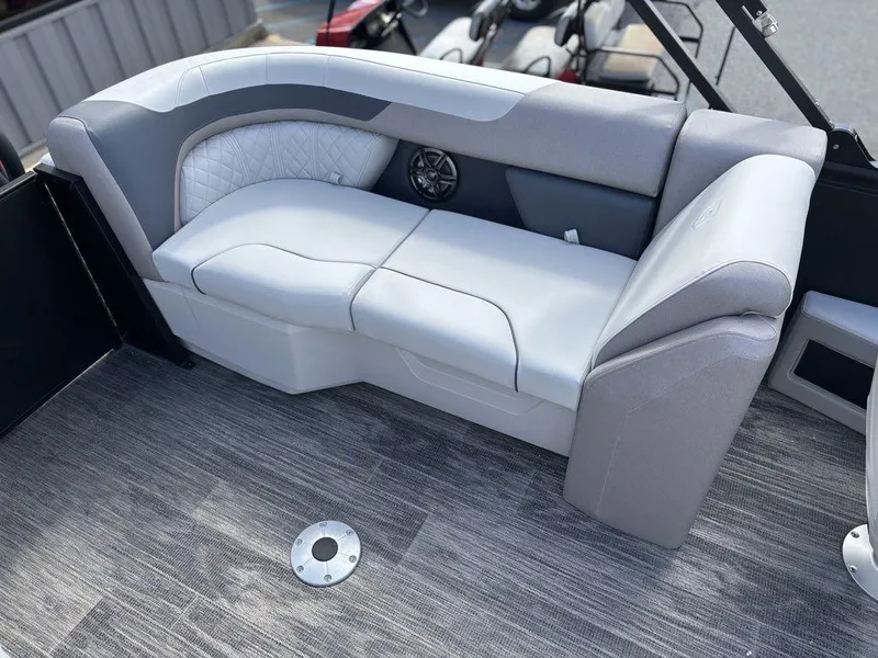 Slide: The Image of 2025 Godfrey SWEETWATER 2286 SB boat interior with gray seating and speaker. - 21
