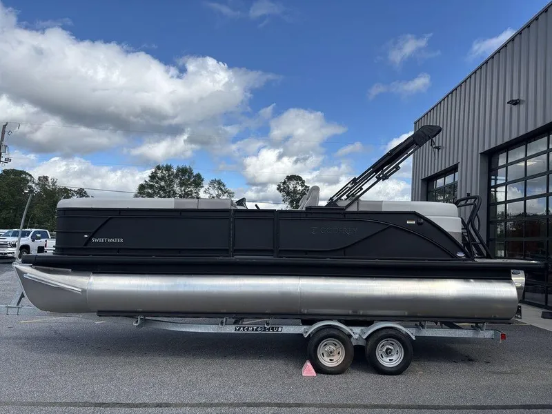 Slide: The Image of 2025 Godfrey SWEETWATER 2286 SB pontoon boat on trailer, parked outdoors. - 8