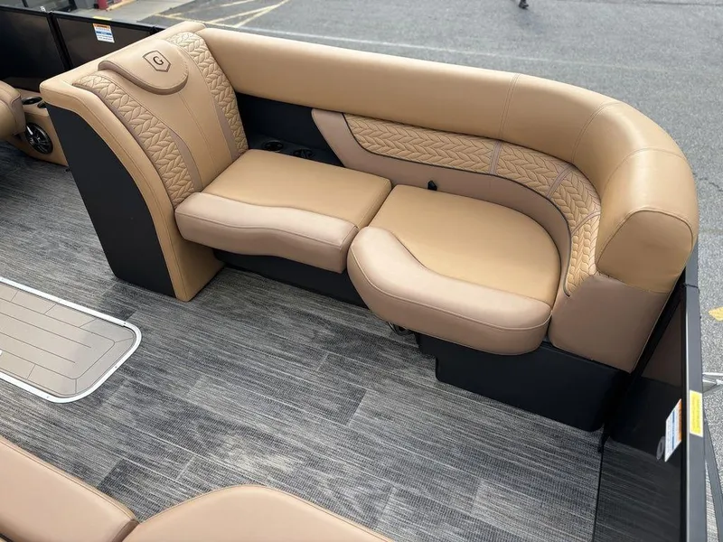 Slide: The Image of Luxurious seating on 2025 Godfrey Monaco 235 SB boat, featuring elegant tan upholstery. - 10