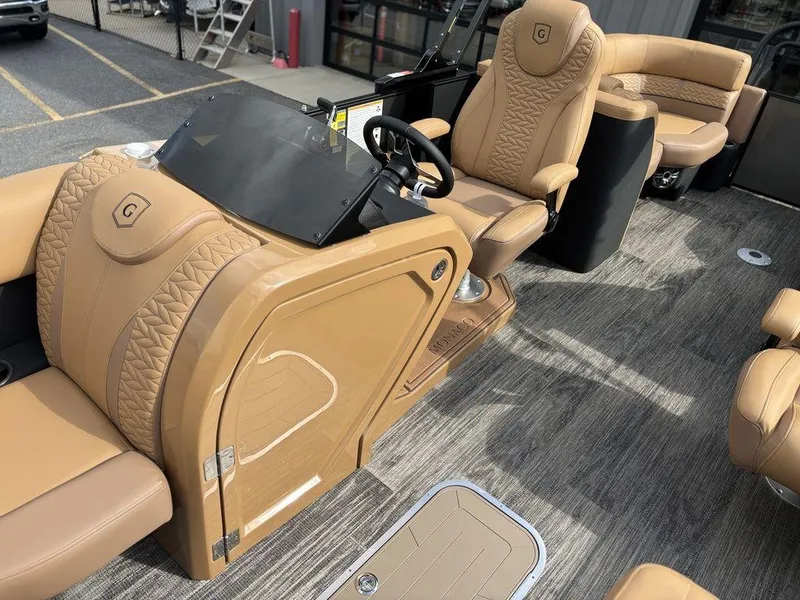 Slide: The Image of Luxurious interior of 2025 Godfrey Monaco 235 SB pontoon boat with tan leather seating. - 13