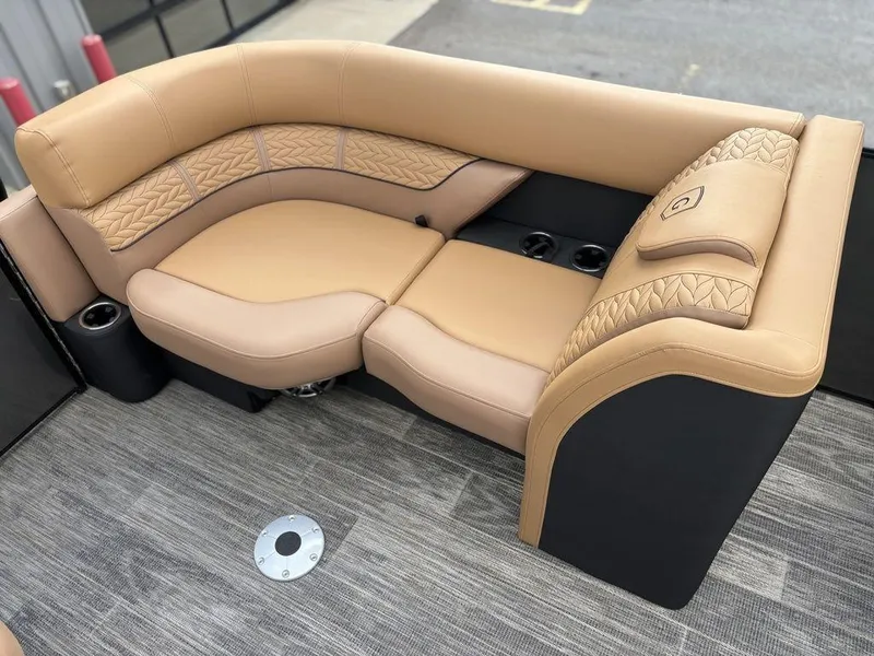 Slide: The Image of Luxurious seating on 2025 Godfrey Monaco 235 SB boat, featuring tan upholstery and elegant design. - 16