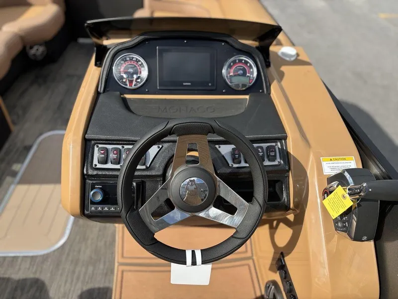 Slide: The Image of 2025 Godfrey Monaco 235 SB dashboard with steering wheel and control panel. - 19