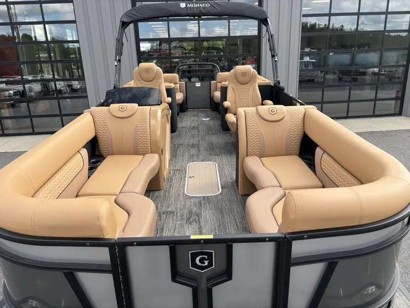 Slide: The Image of 2025 Godfrey Monaco 235 SB pontoon boat with luxurious tan seating and modern design. - 8