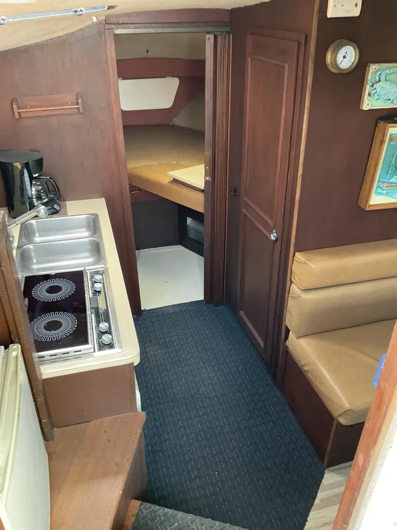 Slide: The Image of 1985 Cruisers Yachts 291 Sea Devil interior with kitchenette and seating area. - 10