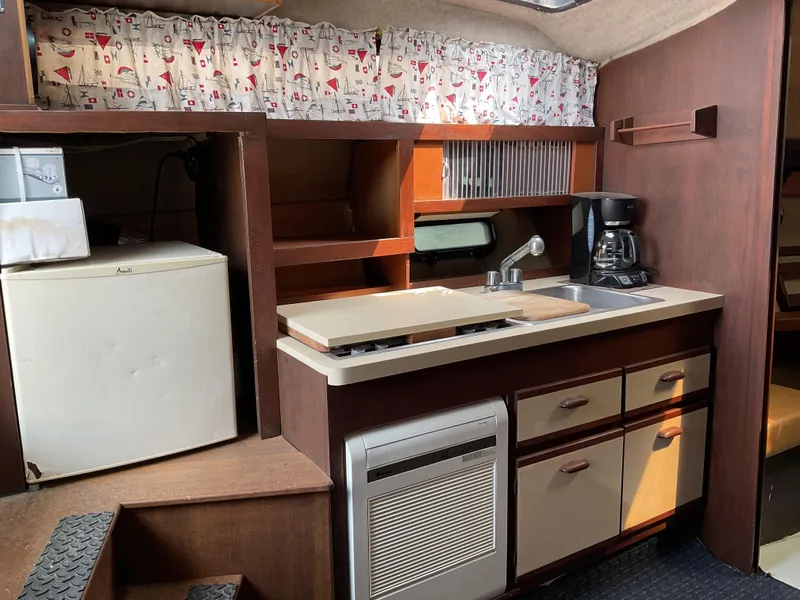 Slide: The Image of 1985 Cruisers Yachts 291 Sea Devil kitchen with fridge, sink, and coffee maker. - 15