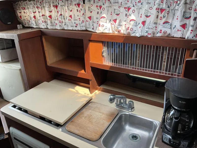 Slide: The Image of 1985 Cruisers Yachts 291 Sea Devil kitchen with sink, cutting board, and coffee maker. - 16