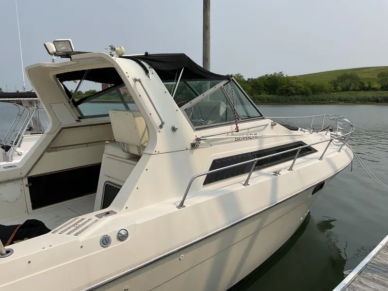 Slide: The Image of 1985 Cruisers Yachts 291 Sea Devil docked on calm water. - 2