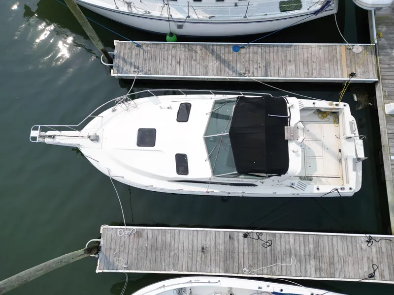 Slide: The Image of 1985 Cruisers Yachts 291 Sea Devil docked at marina, aerial view. - 7