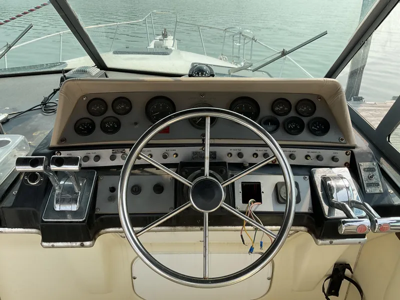 Slide: The Image of 1985 Cruisers Yachts 291 Sea Devil helm with steering wheel and instrument panel. - 9