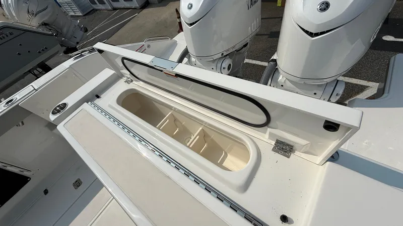 Slide: The Image of 2025 Pursuit S 328 Sport boat with open storage compartment and dual engines. - 15