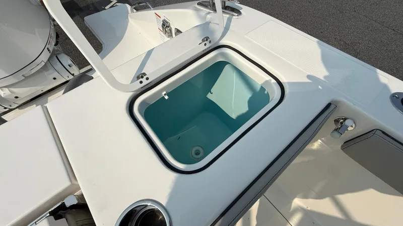 Slide: The Image of 2025 Pursuit S 328 Sport boat with open storage compartment on deck. - 17