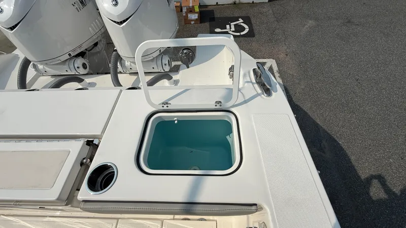 Slide: The Image of 2025 Pursuit S 328 Sport boat with open storage compartment and dual engines. - 18