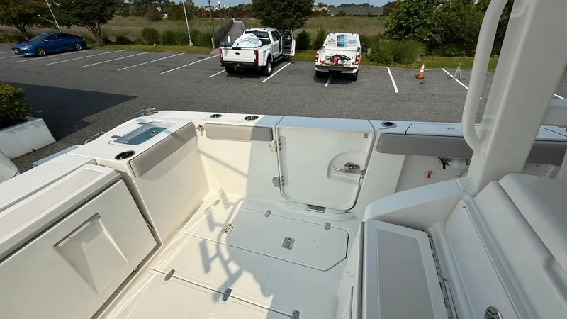 Slide: The Image of 2025 Pursuit S 328 Sport boat interior with spacious deck and storage compartments. - 19