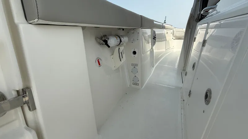 Slide: The Image of 2025 Pursuit S 328 Sport boat interior with sleek white design and modern features. - 21