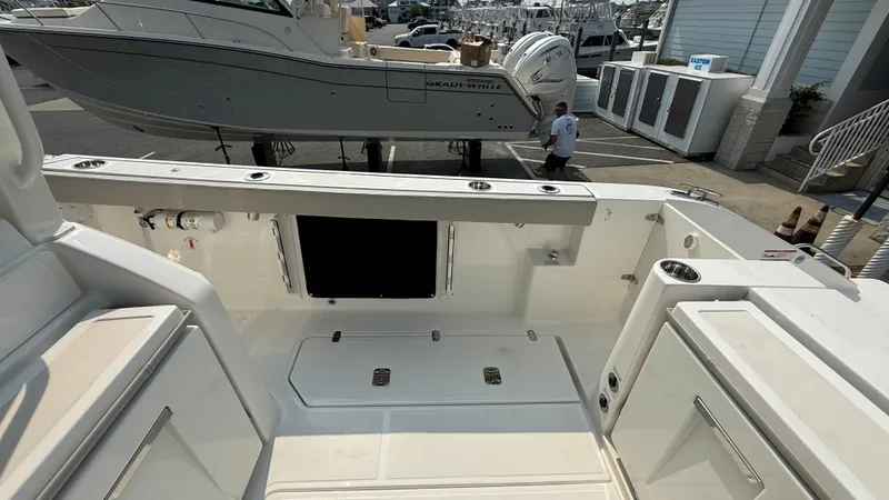 Slide: The Image of 2025 Pursuit S 328 Sport boat interior, featuring spacious deck and storage compartments. - 25