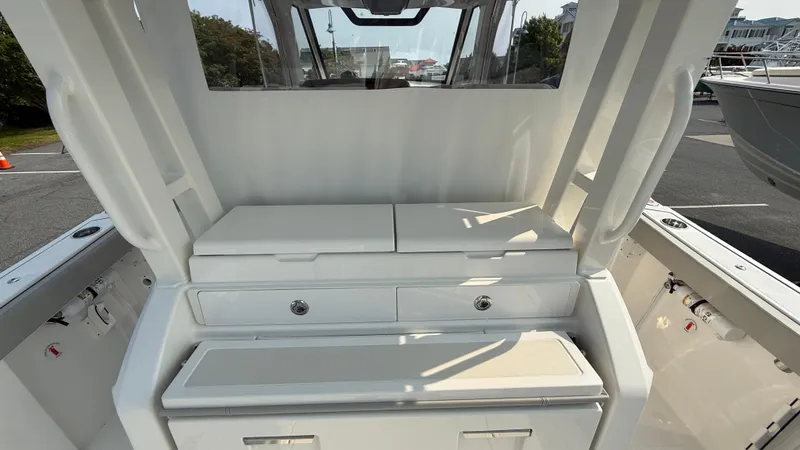 Slide: The Image of 2025 Pursuit S 328 Sport boat interior with storage compartments and seating. - 32