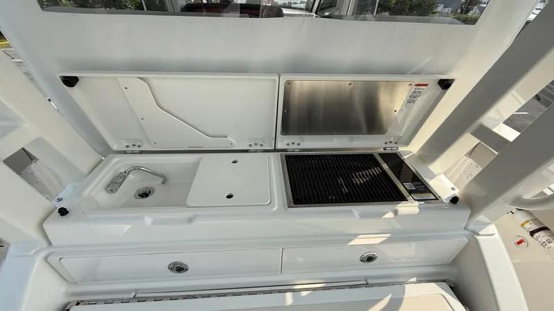 Slide: The Image of 2025 Pursuit S 328 Sport boat kitchen with sink and grill. - 33