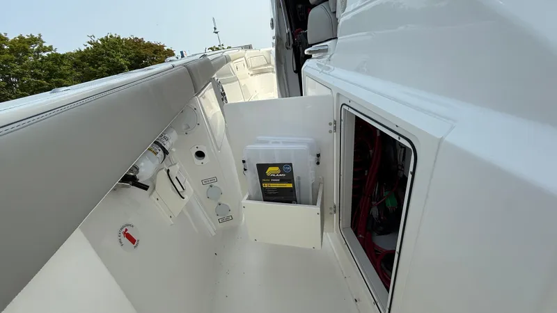 Slide: The Image of 2025 Pursuit S 328 Sport boat interior with storage compartments and control panel. - 37