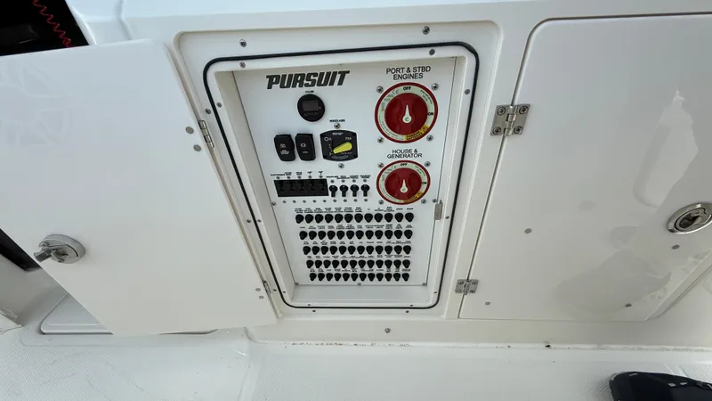 Slide: The Image of Control panel of 2025 Pursuit S 328 Sport boat with switches and indicators. - 38