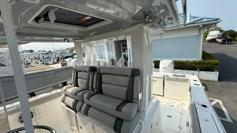Slide: The Image of 2025 Pursuit S 328 Sport boat interior with luxurious seating and modern design. - 39