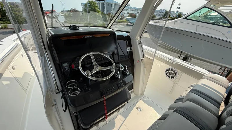 Slide: The Image of 2025 Pursuit S 328 Sport boat interior with steering wheel and seating. - 40