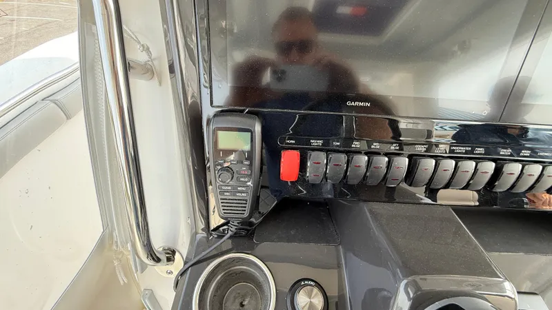 Slide: The Image of Control panel of 2025 Pursuit S 328 Sport boat with radio and switches. - 43