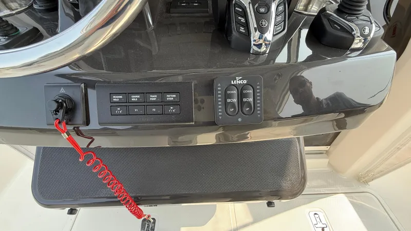 Slide: The Image of Control panel of 2025 Pursuit S 328 Sport boat with steering wheel and switches. - 45