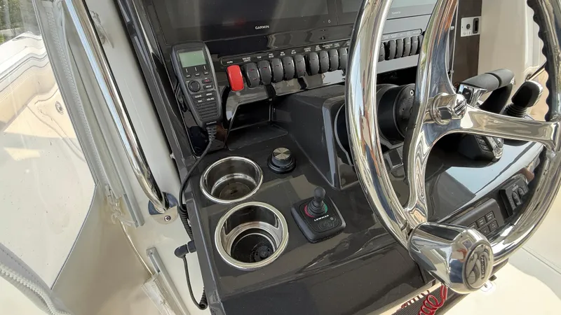 Slide: The Image of 2025 Pursuit S 328 Sport boat dashboard with steering wheel and controls. - 46