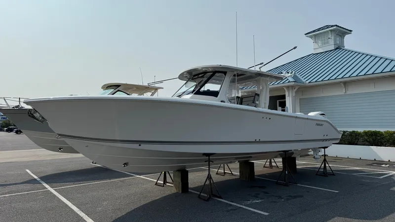 Slide: The Image of 2025 Pursuit S 328 Sport boat on stands in a parking lot. - 7