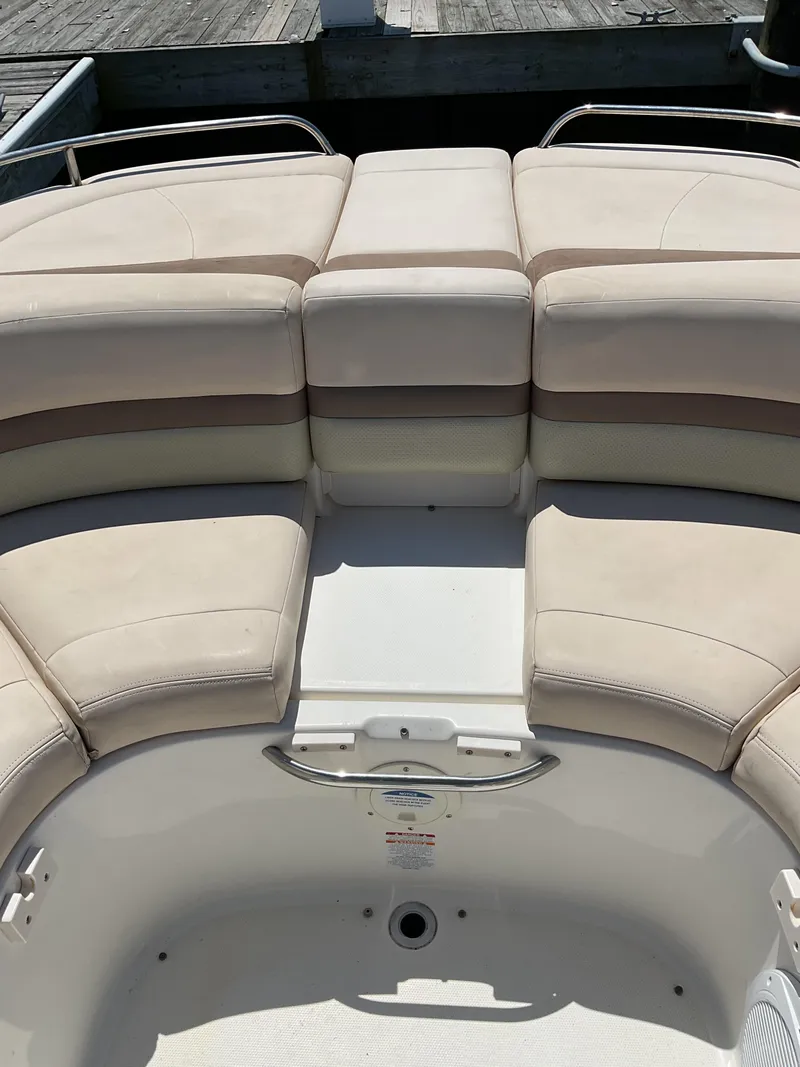 Slide: The Image of 2006 Chaparral 256 SSi boat interior with beige seating and open deck space. - 4