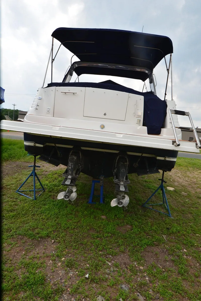 Slide: The Image of 2006 Rinker 342 Fiesta Vee boat on stands, rear view, with dual propellers. - 15