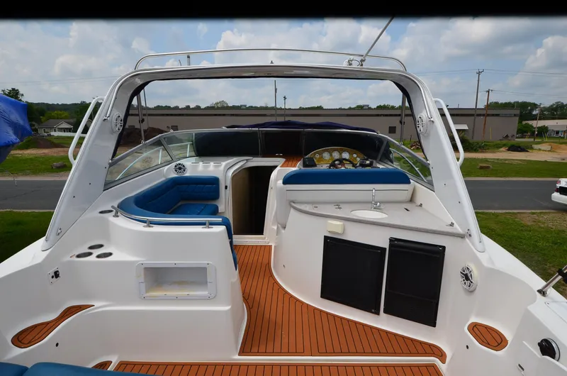 Slide: The Image of 2006 Rinker 342 Fiesta Vee boat interior with wood flooring and blue seating. - 16