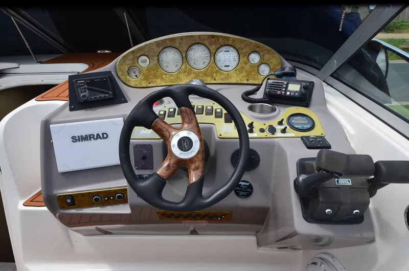 Slide: The Image of 2006 Rinker 342 Fiesta Vee boat dashboard with steering wheel and navigation instruments. - 17