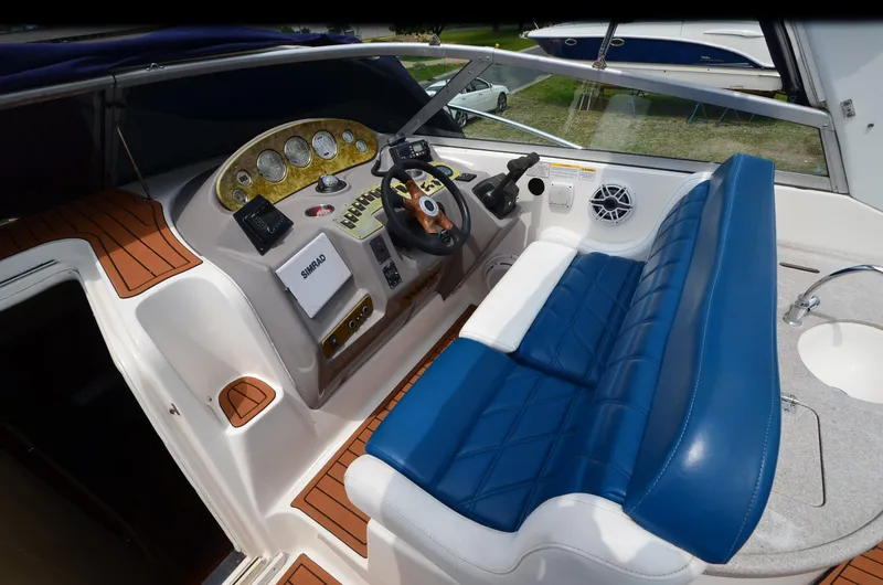 Slide: The Image of 2006 Rinker 342 Fiesta Vee boat cockpit with blue seating and control panel. - 18