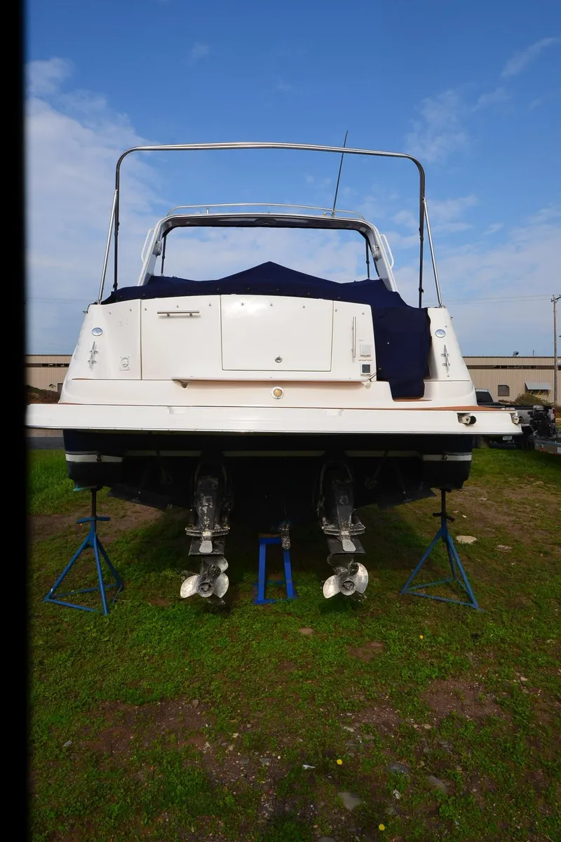 Slide: The Image of 2006 Rinker 342 Fiesta Vee boat on stands, rear view, outdoors. - 2