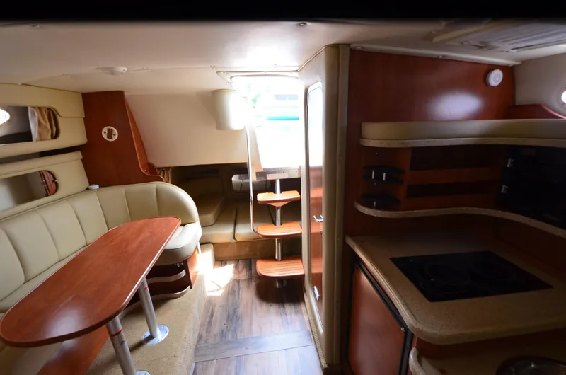 Slide: The Image of Interior of 2006 Rinker 342 Fiesta Vee boat with seating and kitchenette. - 27