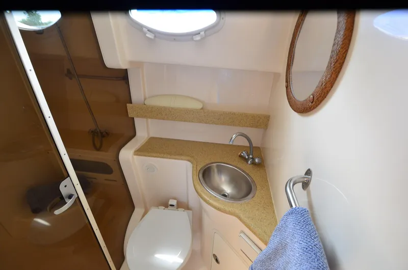 Slide: The Image of 2006 Rinker 342 Fiesta Vee bathroom with sink, toilet, and mirror. - 31