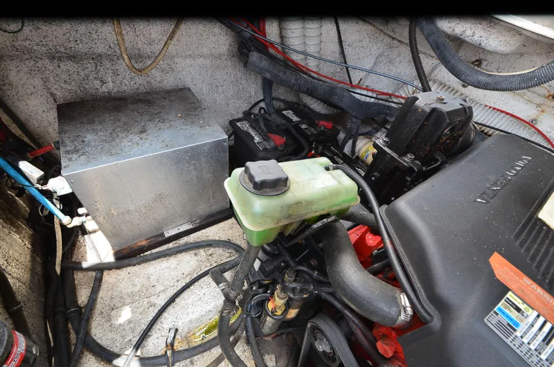 Slide: The Image of Engine compartment of a 2006 Rinker 342 Fiesta Vee boat, showing batteries and components. - 34