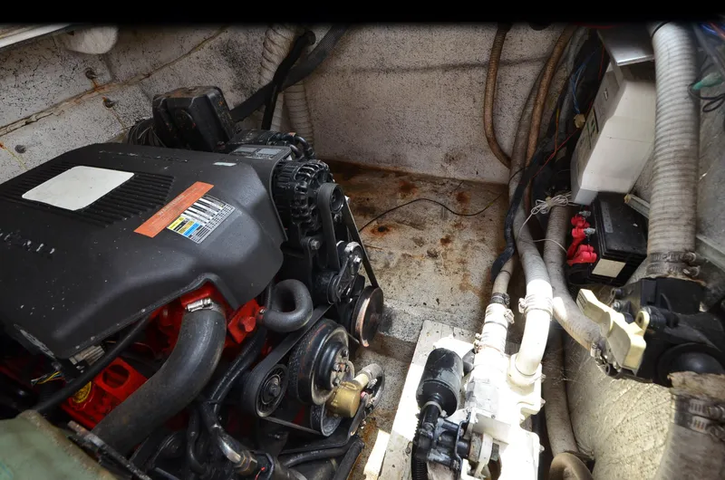 Slide: The Image of Engine compartment of a 2006 Rinker 342 Fiesta Vee boat, showing mechanical components and wiring. - 35